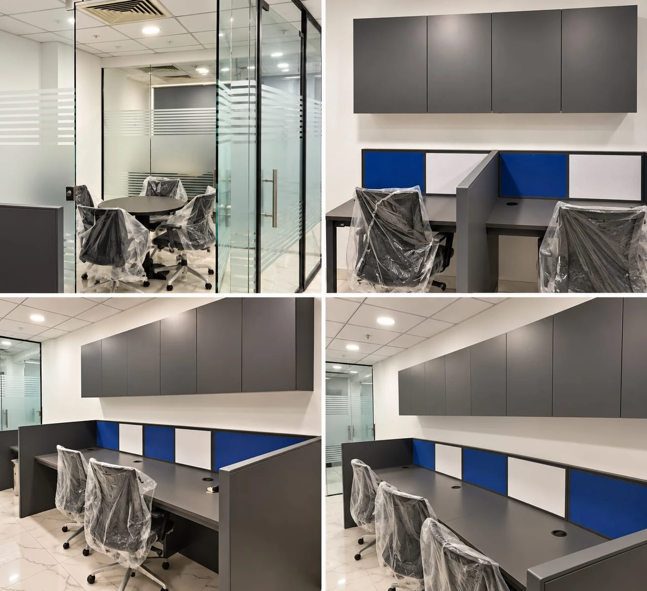 Dark grey workstations with overhead storage and a glass-walled meeting room